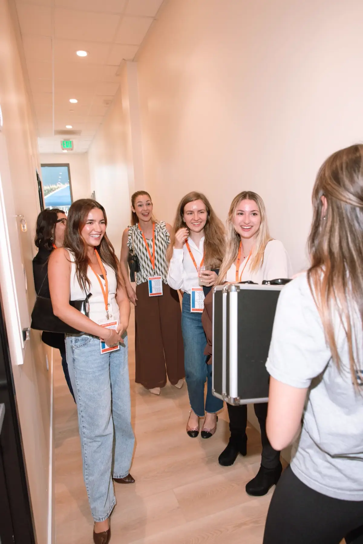 Colleagues gathered in the hallway before a team activity